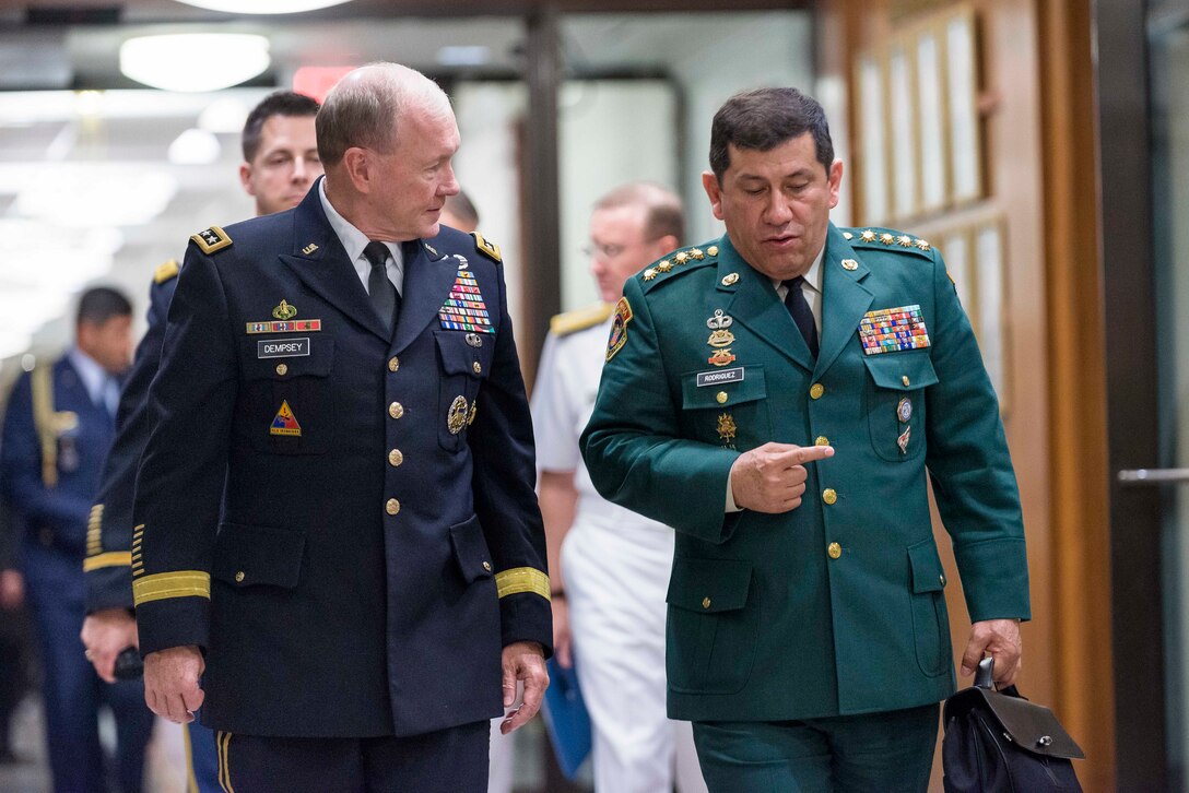 U.S. Army Gen. Martin E. Dempsey, chairman of the Joint Chiefs of Staff, speaks with Colombian Army Gen. Juan Pablo Rodriguez Barragán, commander of Military Forces, as they walk through a corridor at the Pentagon, Sept. 25, 2014. 
