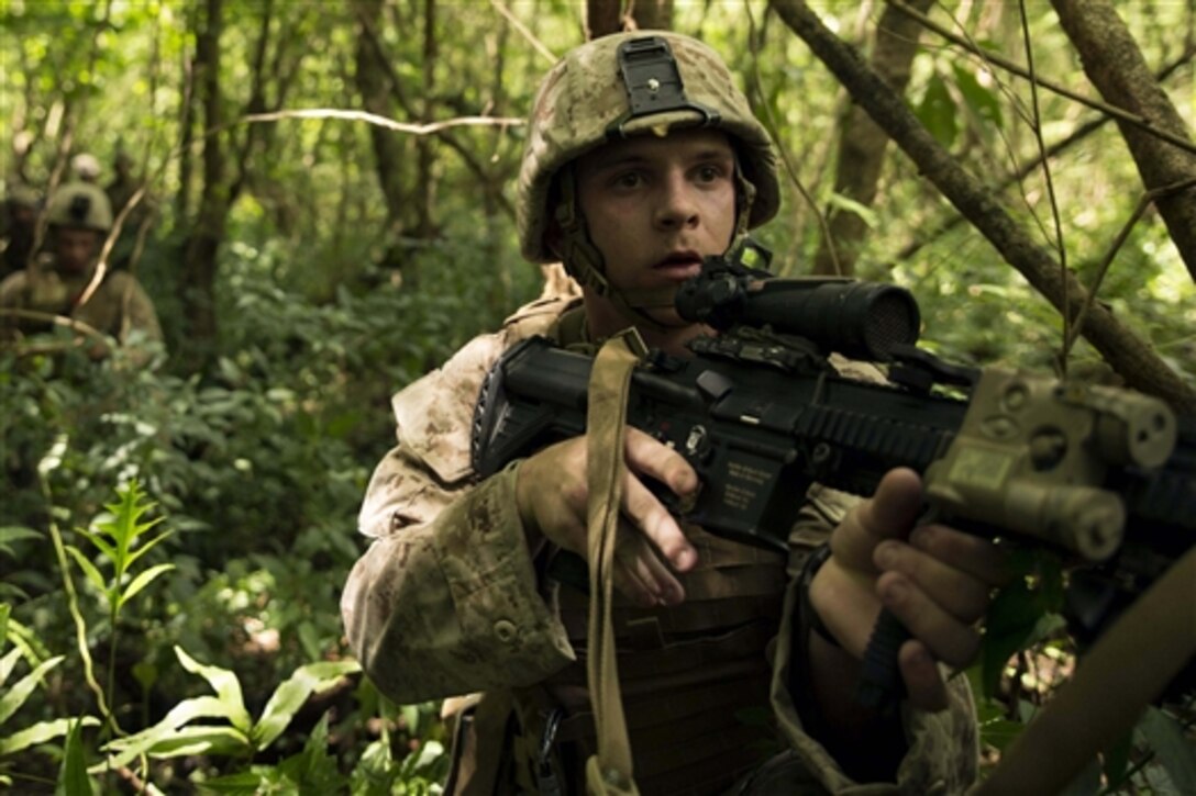 U.S. Marines from the 3rd Marine Expeditionary Force make their way to a compound held by members of the Guam Army National Guard, who are acting as an opposing force during exercise Valiant Shield 2014 on Guam, Sept. 20, 2014.