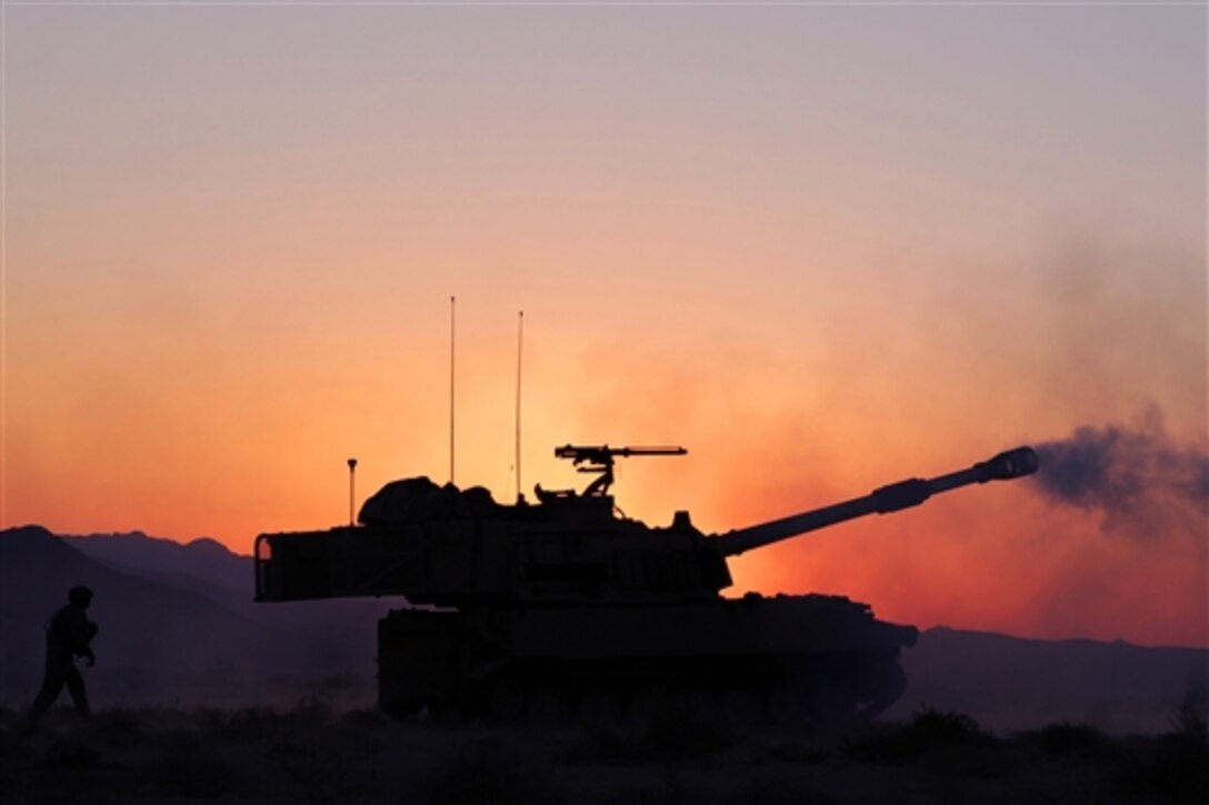 U.S. soldiers fire a Paladin artillery system to calibrate the gun in preparation for Decisive Action Rotation 14-10 at the National Training Center on Fort Irwin, Calif., Sept. 11, 2014.