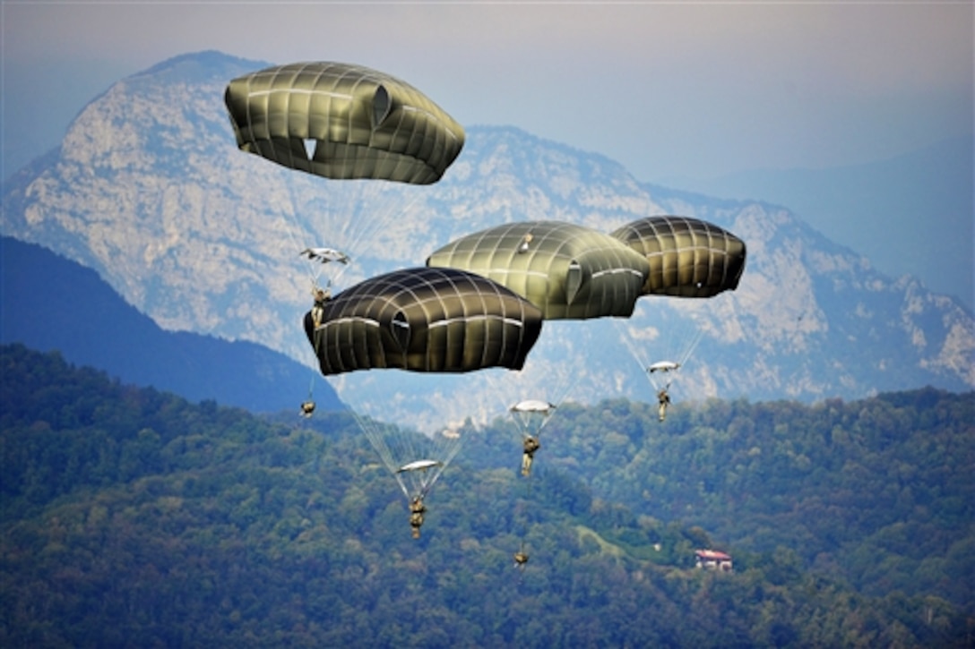 U.S. Army paratroopers descend at Juliet Drop Zone near Pordenone, Italy, Sept. 24, 2014, with the Italian Dolomite mountain range behind them. The paratroopers are assigned to the 173rd Airborne Brigade and based in Vicenza, Italy.