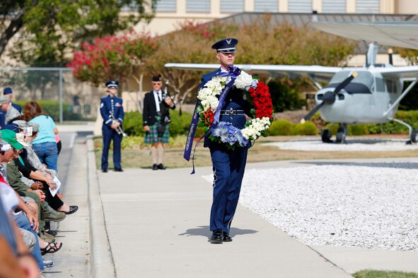 Staff Sgt. Chris Strunk presents a memorial wreath during the annual Anniversary Week Remembrance Ceremony Sept. 26, 2014, at the Air Force Intelligence, Surveillance and Reconnaissance Agency headquarters on Joint Base San Antonio-Lackland. (U.S. Air Force photo/Capt. Andrew Caulk)