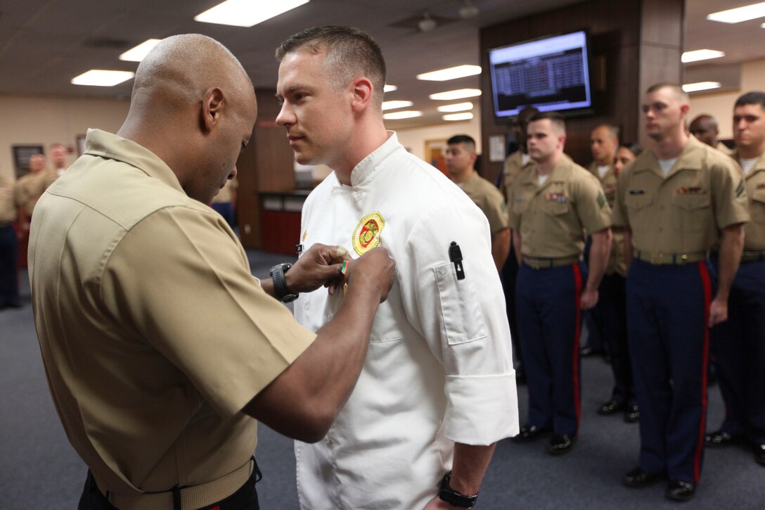 GARDEN CITY, N.Y.—Staff Sgt. Jesse Costa, 1st Marine Corps District’s club manager, receives the Navy and Marine Corps Achievement Medal from Brig. Gen. Terry Williams, commanding general of Eastern Recruiting Region,  Sept. 15, at the 1st MCD headquarters. Costa is on the path to becoming the only chef in his military occupational specialty. (U.S. Marine Corps photo by Lance Cpl. Brandon Thomas)