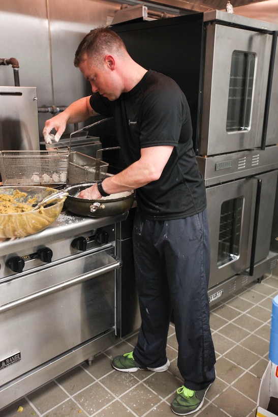 NEW YORK—Staff Sgt. Jesse Costa, 1st Marine Corps District’s club manager, prepares white chocolate rosetta balls for frying, Sept. 18. The rosetta balls are one of the six dishes prepared by the chefs during the special event at Club Space NYC. (U.S. Marine Corps photo by Lance Cpl. Brandon Thomas)