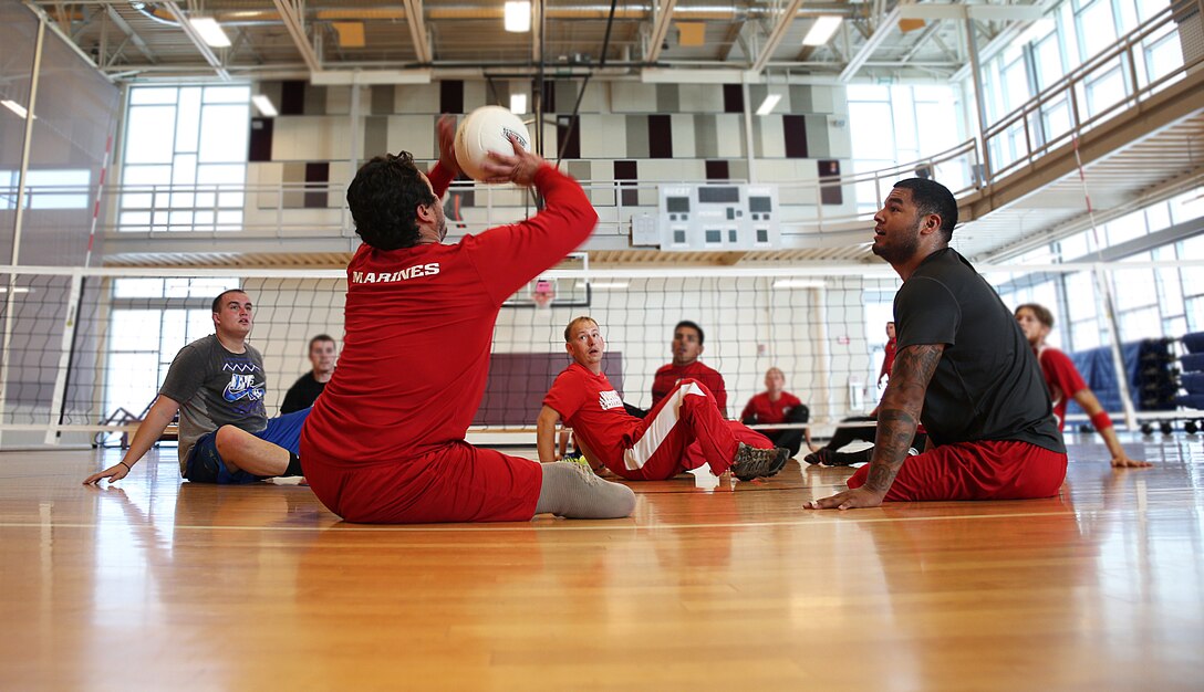 Marines practice returning the ball during sitting volleyball practice for the Marine team, Sept. 26, in preparation for the 2014 Warrior Games. The Marine team has been training since September 15 in order to build team cohesion and acclimate to the above 6,000 feet altitude of Colorado Springs. The Marine team is comprised of both active duty and veteran wounded, ill and injured Marines who are attached to or supported by the Wounded Warrior Regiment, the official unit of the Marine Corps charged with providing comprehensive non-medical recovery care to wounded, ill and injured Marines. The Warrior Games are a Paralympic-style competition for more than 200 wounded, ill and injured service members and are taking place Sept. 28 to Oct. 4 at the Olympic Training Center in Colorado Springs, Colorado. Follow the Marine team's progress at www.facebook.com/wwr.usmc.