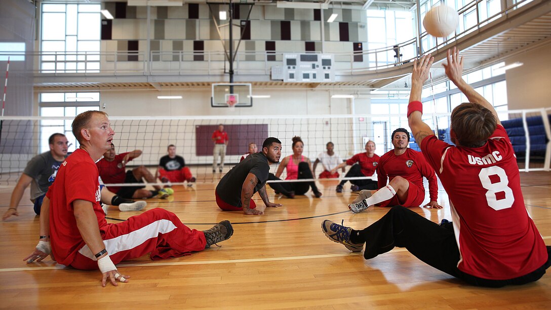 Cpl. Benjamin McCrosky (left), Cpl. Jorge Salazar (center) and Sgt. Eric Rodriguez (right) wait to retun the ball during sitting volleyball practice for the Marine team, Sept. 26, in preparation for the 2014 Warrior Games. The Marine team has been training since September 15 in order to build team cohesion and acclimate to the above 6,000 feet altitude of Colorado Springs. The Marine team is comprised of both active duty and veteran wounded, ill and injured Marines who are attached to or supported by the Wounded Warrior Regiment, the official unit of the Marine Corps charged with providing comprehensive non-medical recovery care to wounded, ill and injured Marines. The Warrior Games are a Paralympic-style competition for more than 200 wounded, ill and injured service members and are taking place Sept. 28 to Oct. 4 at the Olympic Training Center in Colorado Springs, Colorado. Follow the Marine team's progress at www.facebook.com/wwr.usmc.