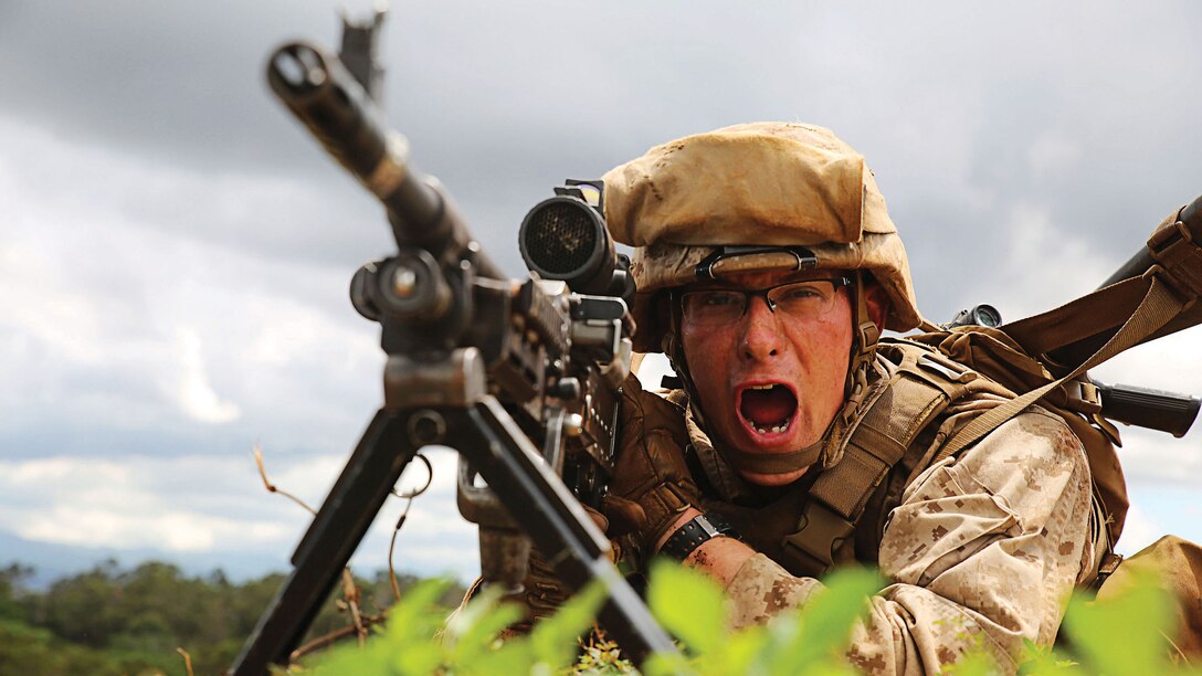 A Marine with Golf Company, 2nd Battalion, 3rd Marine Regiment recites a practical phrase used to simulate the time it takes to send a burst of live fire at KR-5 live-fire range aboard Schofield Barracks, Sept. 19, 2014 as part of the Island Viper exercise. The exercise is meant to prepare Marines for real-world combat. (U.S. Marine Corps photo by Pfc. Harley Thomas)