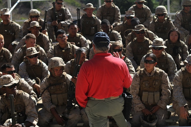 Craig Fairbanks, the leader instructor for the Shotgun Qualification Course explains the course to the Marines of Ammo Company, 1st Supply Battalion aboard Marine Corps Base Camp Pendleton, Calif., Sept. 15, 2014. The range required the Marines to demonstrate proficiency with the M1014 shotgun. The live-fire ranges were part of an annual training package to keep the Marines confident and proficient with each weapon system.