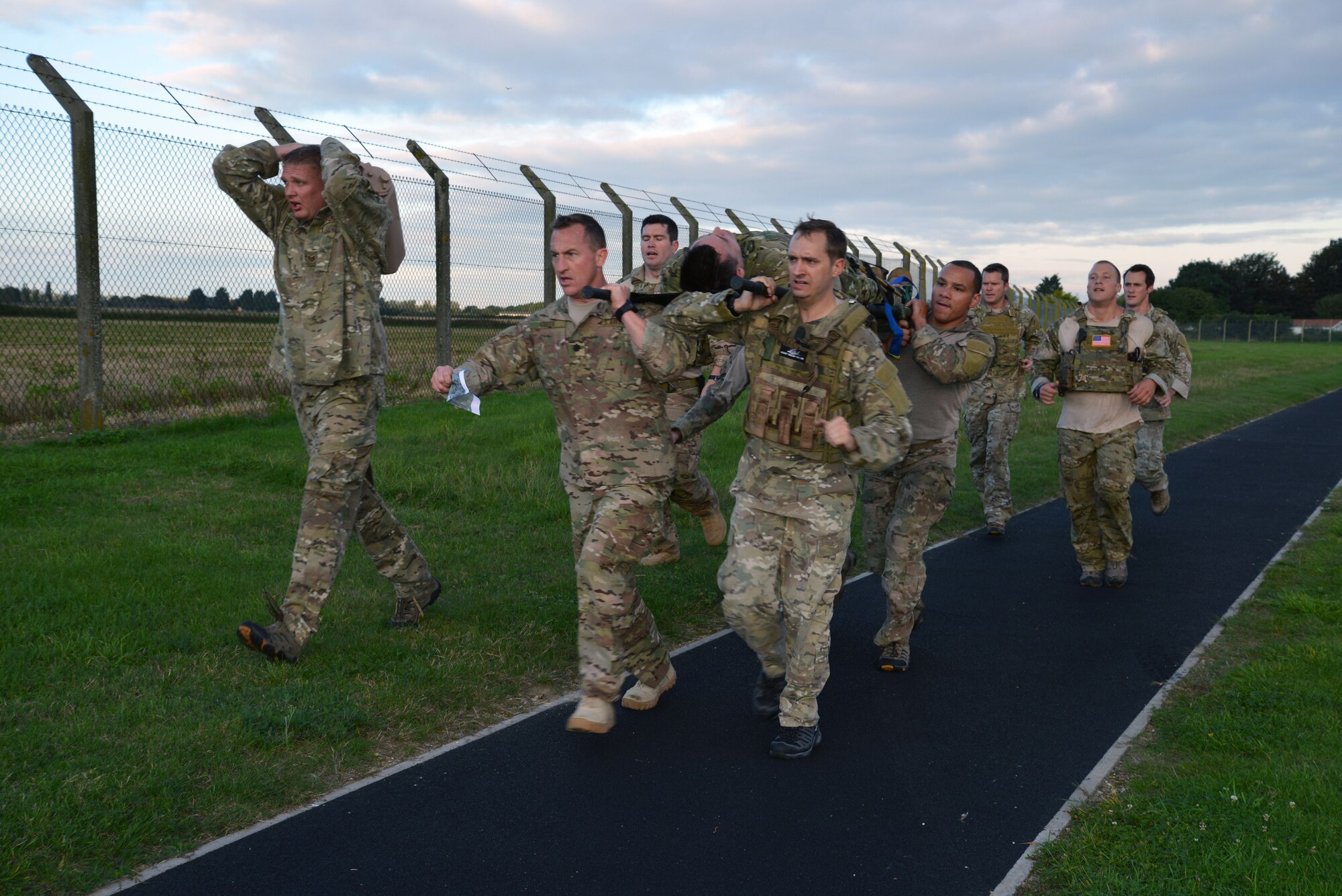 U.S. Air Force Lt. Col. Nathan Green, center, 352nd Special Operations Group commander, and Team 2 carry one of their “injured” teammates Sept. 26, 2014, during the Monster Mash on RAF Mildenhall, England. The Monster Mash consisted of various events such as carrying a Zodiac inflatable boat, marching with a 40-pound rucksack and a blind weapons assembly. A Monster Mash is a long-standing special tactics tradition which combines events designed to test the strength, stamina, and problem solving skills. (U.S. Air Force photo/Tech. Sgt. Stacia Zachary/Released)