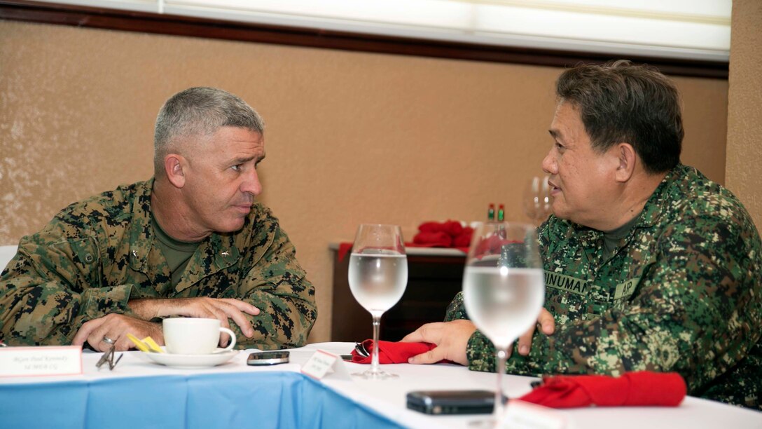 U.S. Marine Brig. Gen. Paul Kennedy, left, talks with Philippine Navy Cmdr. Manuel Abinuman in Puerto Princesa, Palawan, Philippines Sept. 29 after the opening ceremony for Amphibious Landing Exercise 2015. PHIBLEX is an annual, bilateral training exercise conducted by the Armed Forces of the Philippines, U.S. Marines and Navy to strengthen interoperability across a range of capabilities, including disaster relief and contingency operations. Kennedy is the commanding general of 3rd Marine Expeditionary Brigade, 3rd MEB, III Marine Expeditionary Force. Abinuman is the Naval Forces West Commander, Armed Forces of the Philippines.