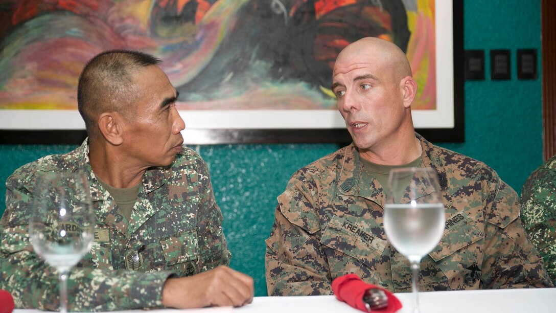 U.S. Marine Sgt. Maj. Howard Kreamer, right, talks with Philippine Marine Sgt. Maj. Jamie Ardiente in Puerto Princesa, Palawan Sept. 29 after the opening ceremony for Amphibious Landing Exercise 2015. PHIBLEX is an annual, bilateral training exercise conducted by the Armed Forces of the Philippines, U.S. Marines and Navy to strengthen interoperability across a range of capabilities, including disaster relief and contingency operations. Kreamer is the sergeant major of 3rd Marine Expeditionary Brigade, 3rd MEB, III Marine Expeditionary Force, and Ardiente is the 3rd Marine Brigade Sergeant Major, Armed Forces of the Philippines. 