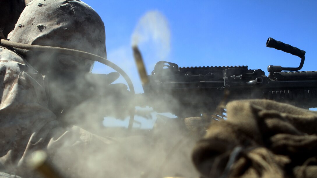 Lance Corporal Dashaun Dancy, an ammo technician with Ammo Company, 1st Supply Battalion fires an M249 SAW aboard Marine Corps Base Camp Pendleton, Calif., Sept. 17, 2014. The Marines were required to engage simulated targets with weapons ranging from M1014 Benelli shotguns to AT-4 rocket launchers. The live-fire ranges were part of an annual training package to keep the Marines confident and proficient with each weapon system.