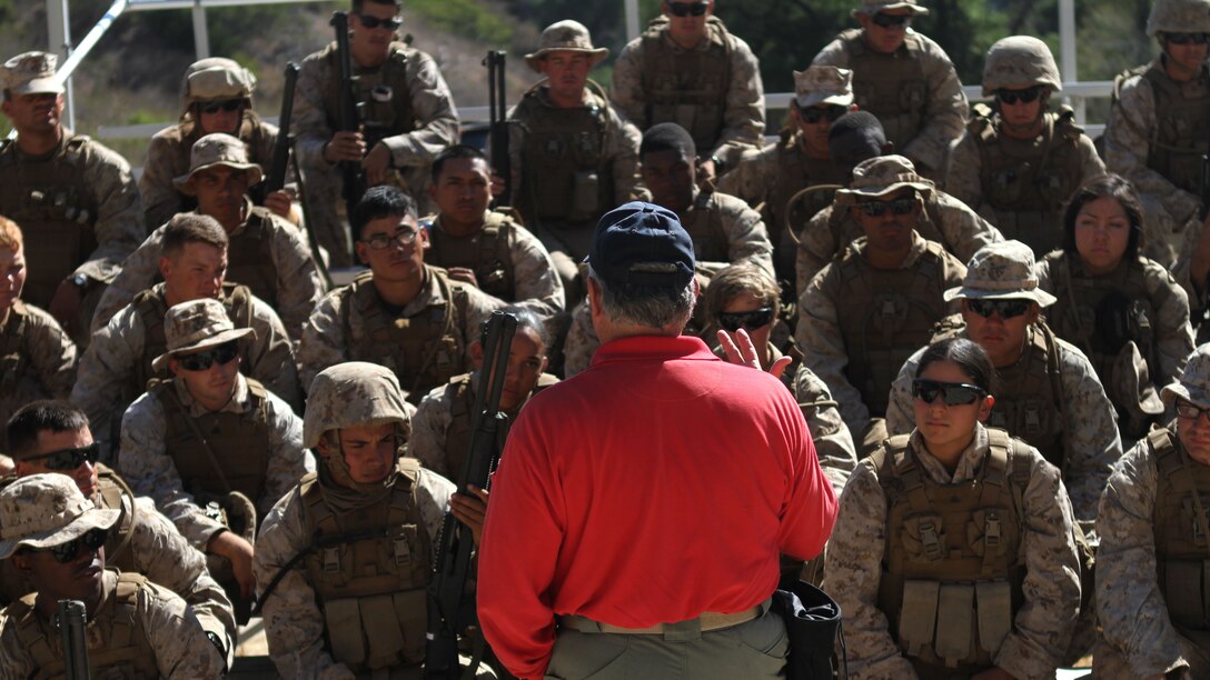 Craig Fairbanks, the leader instructor for the Shotgun Qualification Course explains the course to the Marines of Ammo Company, 1st Supply Battalion aboard Marine Corps Base Camp Pendleton, Calif., Sept. 15, 2014. The range required the Marines to demonstrate proficiency with the M1014 shotgun. The live-fire ranges were part of an annual training package to keep the Marines confident and proficient with each weapon system.