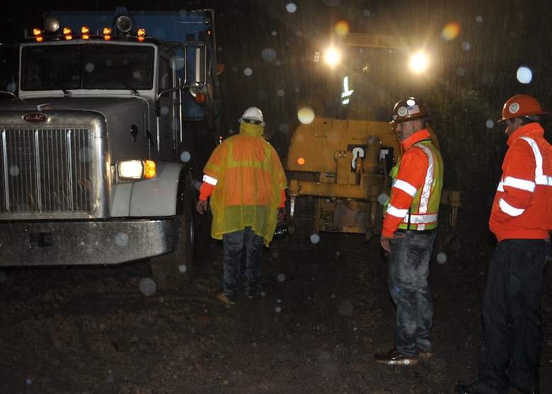 Workers with West Point Construction inspect their equipment near midnight on Sept. 17 as they prepare to continue emergency operations on the levee in Duncan, Ariz.  The company was the contractor for the U.S. Army Corps of Engineers Los Angeles District’s response team in response to a request from the State of Arizona’s Division of Emergency Management for assistance to help prevent a levee from breaching during a severe rainstorm which came as a result of Tropical Storm Odile. 