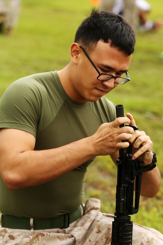 Lance Cpl. Davey Villalobos assembles an M-16A4 service rifle during the rifle relay at Marine Corps Air Station Cherry Point, N.C., Sept. 26, 2014. The rifle relay was an event of the 2014 Fall Field Meet between Headquarters and Headquarters Squadron and Marine Wing Headquarters Squadron 2. Villalobos a native of Reno, Nev., is an administrative specialist with MWHS-2.