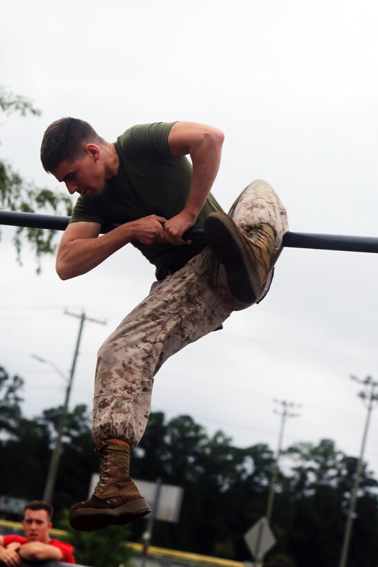 Lance Cpl. Galen Wedde navigates through a section of an obstacle course during a field meet at Marine Corps Air Station Cherry Point, N.C., Sept. 26, 2014. The course was one of 11 events Marines and Sailors competed in during the 2014 Fall Field Meet between Headquarters and Headquarters Squadron and Marine Wing Headquarters Squadron 2. Wedde, native of Aurora, Colo., is an aircraft ordnance technician with H&HS.