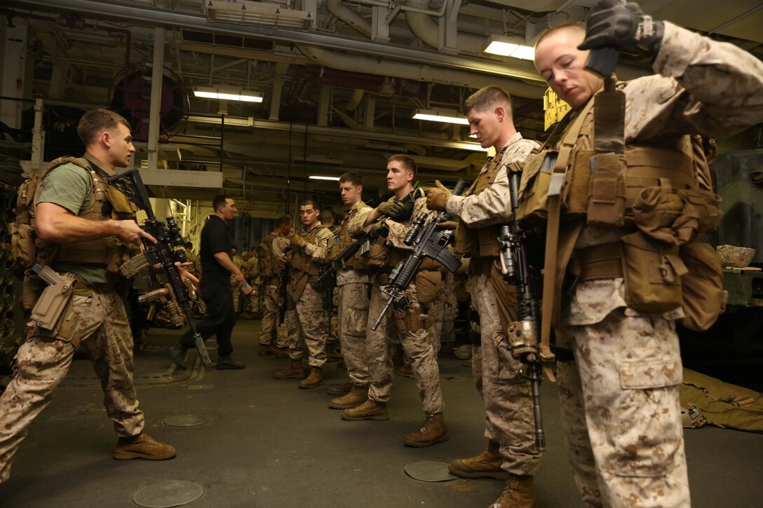 Marines with the 11th Marine Expeditionary Unit (MEU), participate in close quarters tactics drills in the well deck of the USS Makin Island, Sept. 25. The purpose of the training was to hone weapons handling skills and rapid response techniques. Marines with the 11th MEU are deployed with the Makin Island Amphibious Ready Group as a flexible, adaptable and persistent force in the U.S. 5th Fleet area of responsibility. (U.S. Marine Corps photo by Cpl. Demetrius Morgan/RELEASED)