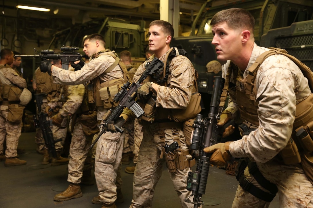 Marines with Charlie Battery, 11th Marine Expeditionary Unit (MEU), participate in close quarters tactics drills in the well deck of the USS Makin Island, Sept. 25. The purpose of the training was to hone weapons handling skills and rapid response techniques. The 11th MEU is deployed with the Makin Island Amphibious Ready Group as a theater reserve and crisis response force throughout U.S. Central Command and the U.S 5th fleet area of responsibility. (U.S. Marine Corps photo by Cpl. Demetrius Morgan/RELEASED)