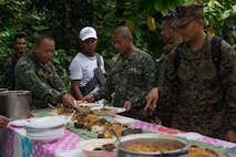 U.S. Navy corpsman and Armed Forces of the Philippines eat together during a Medical Civic Action Program leading up to Amphibious Landing Exercise 15 (PHIBLEX 15) in Palawan, Philippines, September 19, 2014. PHIBLEX 15 is an annual, bilateral training exercise conducted by the Armed Forces of the Philippines, U.S. Marines and Navy to strengthen interoperability across a range of capabilities to include disaster relief and contingency operations. 
(U.S. Marine Corps photo by III MEF Combat Camera Pfc. Matthew Casbarro/Released)
