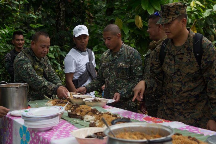 U.S. Navy corpsman and Armed Forces of the Philippines eat together during a Medical Civic Action Program leading up to Amphibious Landing Exercise 15 (PHIBLEX 15) in Palawan, Philippines, September 19, 2014. PHIBLEX 15 is an annual, bilateral training exercise conducted by the Armed Forces of the Philippines, U.S. Marines and Navy to strengthen interoperability across a range of capabilities to include disaster relief and contingency operations. 
(U.S. Marine Corps photo by III MEF Combat Camera Pfc. Matthew Casbarro/Released)
