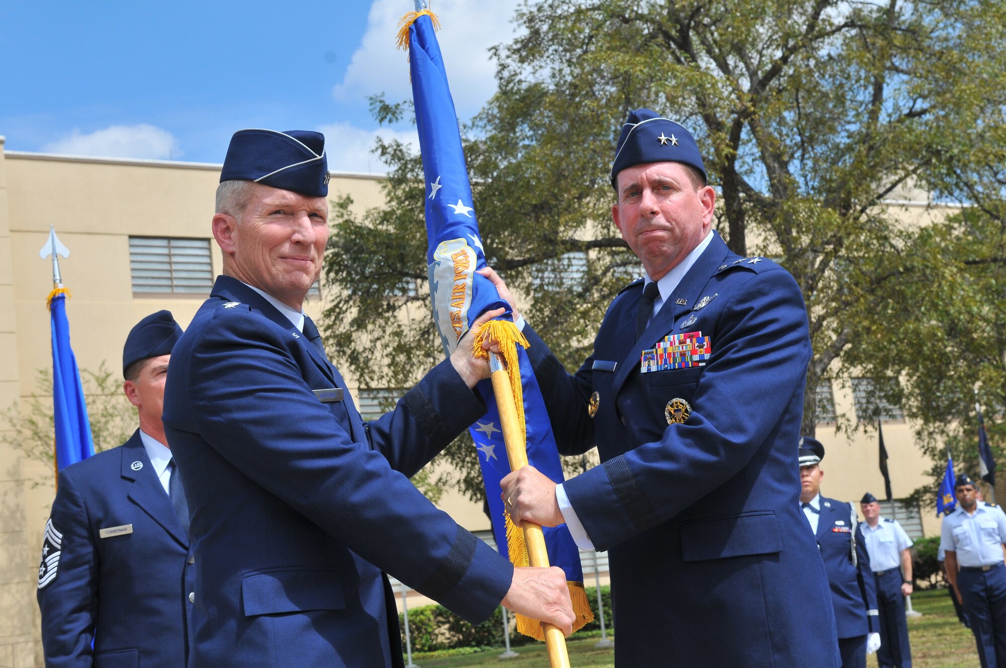 Gen. Mike Hostage, Commander of Air Combat Command, left, passes the guidon of Twenty-Fifth Air Force to Maj. Gen. John Shanahan who assumed command of the newest Numbered Air Force during  the re-designation ceremony of the Air Force Intelligence, Surveillance and Reconnaissance Agency to 25 AF Sept. 29 on Joint Base San Antonio - Lackland's Security Hill. (U.S. Air Force photo by William Belcher)    