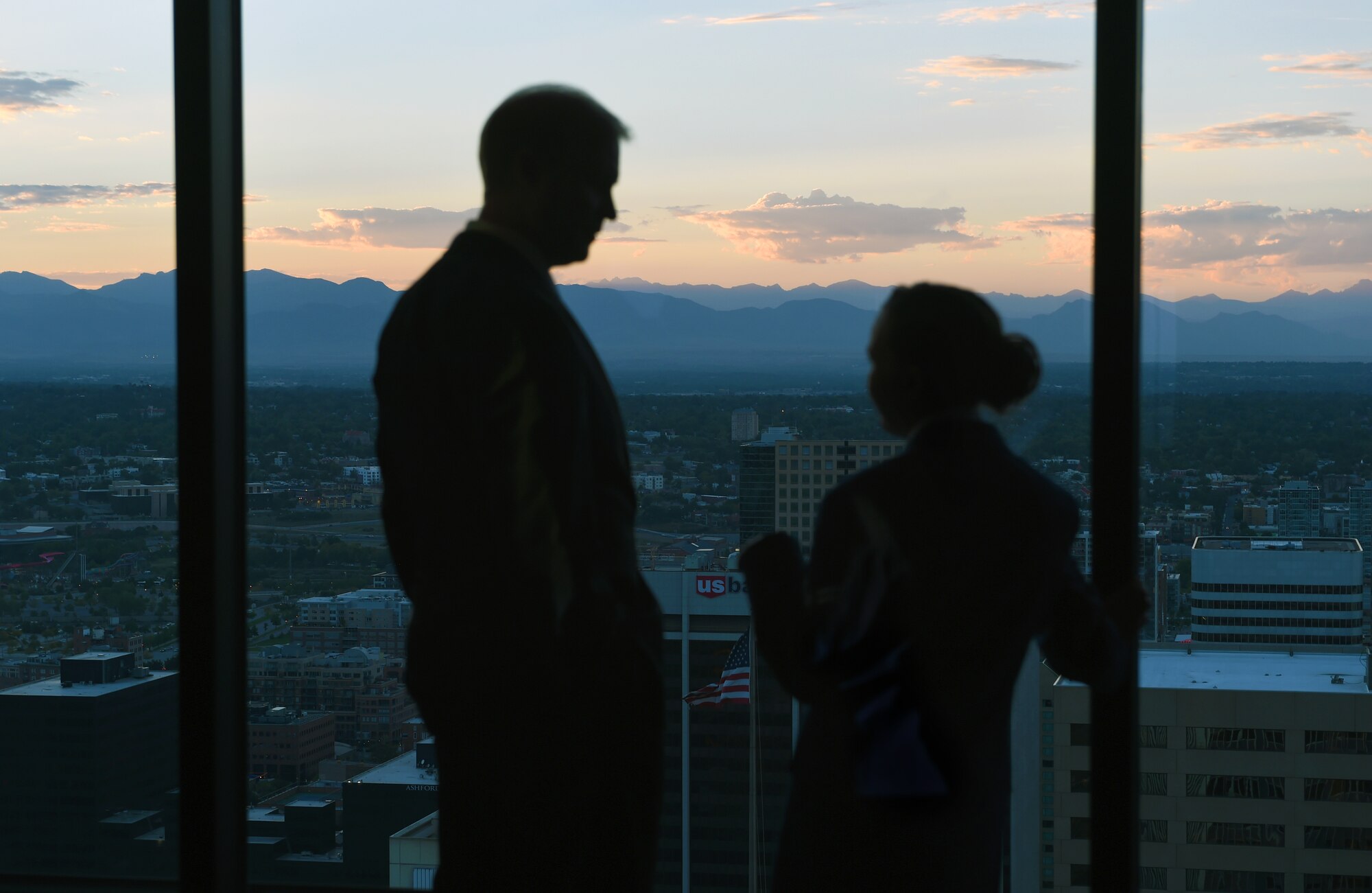 Team Buckley members overlook the city during the Air Force Ball and 460th Space Wing 10th anniversary celebration Sept. 27, 2014, at the Grand Hyatt Hotel in Denver. Every year, the Air Force celebrates its birthday with a formal military ball and festivities many people remember for a lifetime. Buckley Air Force Base did their part to wish the Air Force and the 460th SW a happy birthday with dinner, a guest speaker and a nighttime celebration. (U.S. Air Force photo by Airman Emily E. Amyotte/Released)