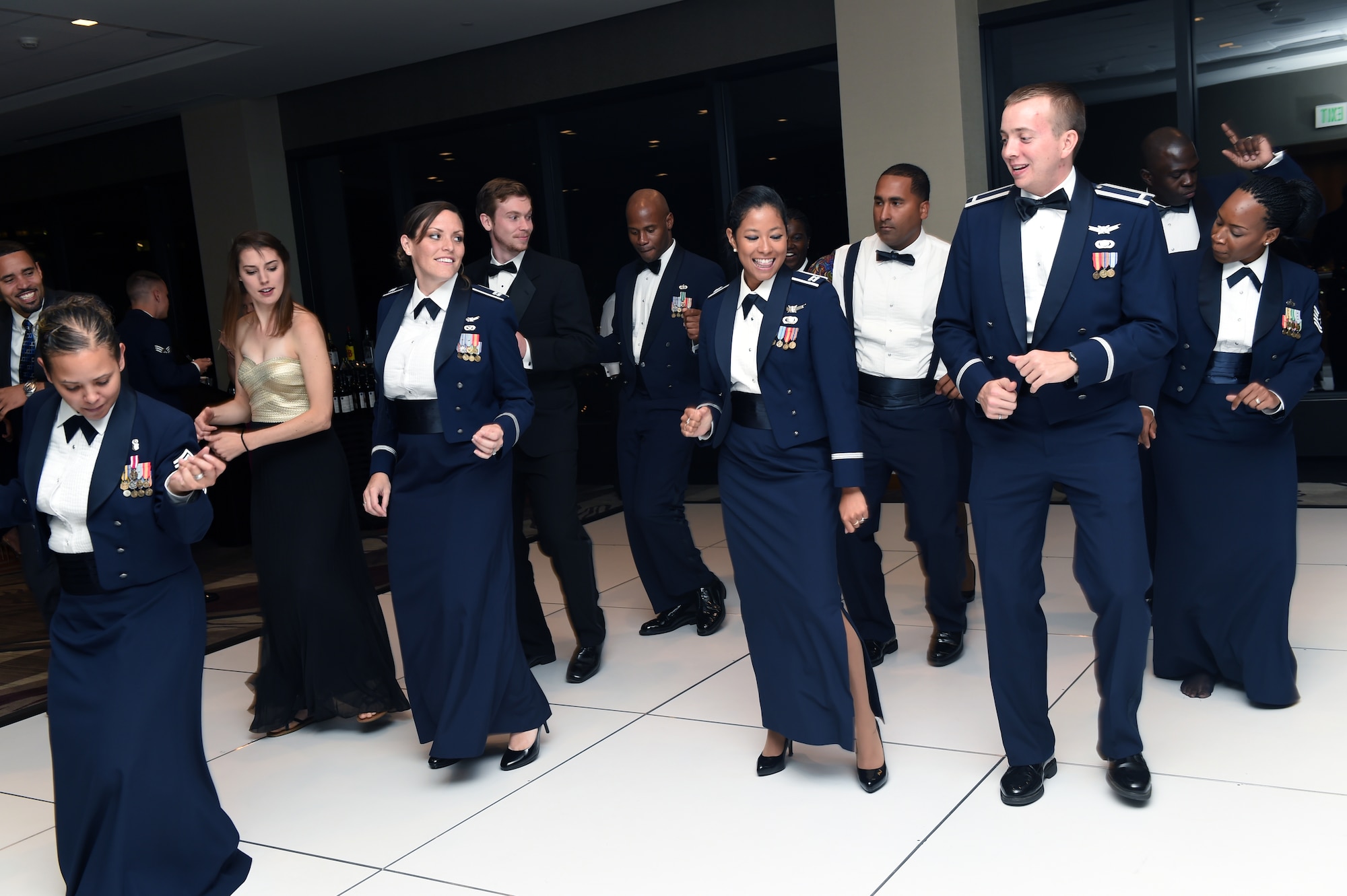 Team Buckley members enjoy the Air Force Ball and 460th Space Wing 10th anniversary celebration Sept. 27, 2014, at the Grand Hyatt Hotel in Denver. Every year, the Air Force celebrates its birthday with a formal military ball and festivities many people remember for a lifetime. Buckley Air Force Base did their part to wish the Air Force and the 460th SW a happy birthday with dinner, a guest speaker and a nighttime celebration. (U.S. Air Force photo by Airman Emily E. Amyotte/Released)