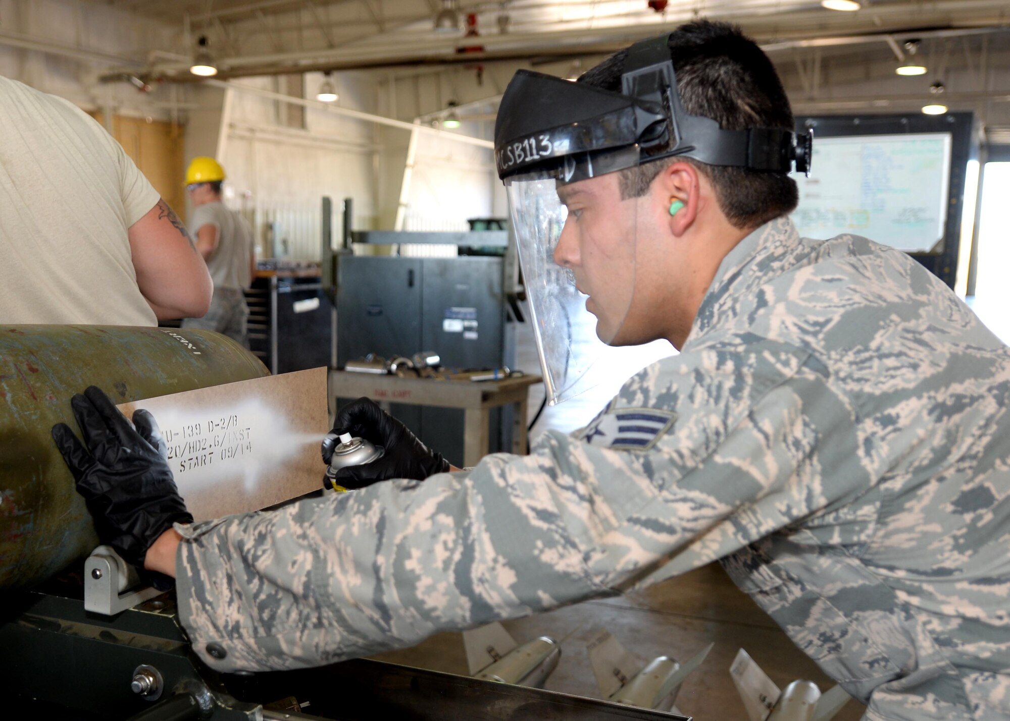 Senior Airman Anthony Anderson, 28th Munitions Squadron munitions inspector, spray paints a lot number onto a GBU-38 during the Global Strike Challenge at Ellsworth Air Force Base, S.D., Sept. 26, 2014. Conventional maintenance crews trained for 10 weeks in preparation for the competition. (U.S. Air Force photo by Airman 1st Class Rebecca Imwalle/Released)