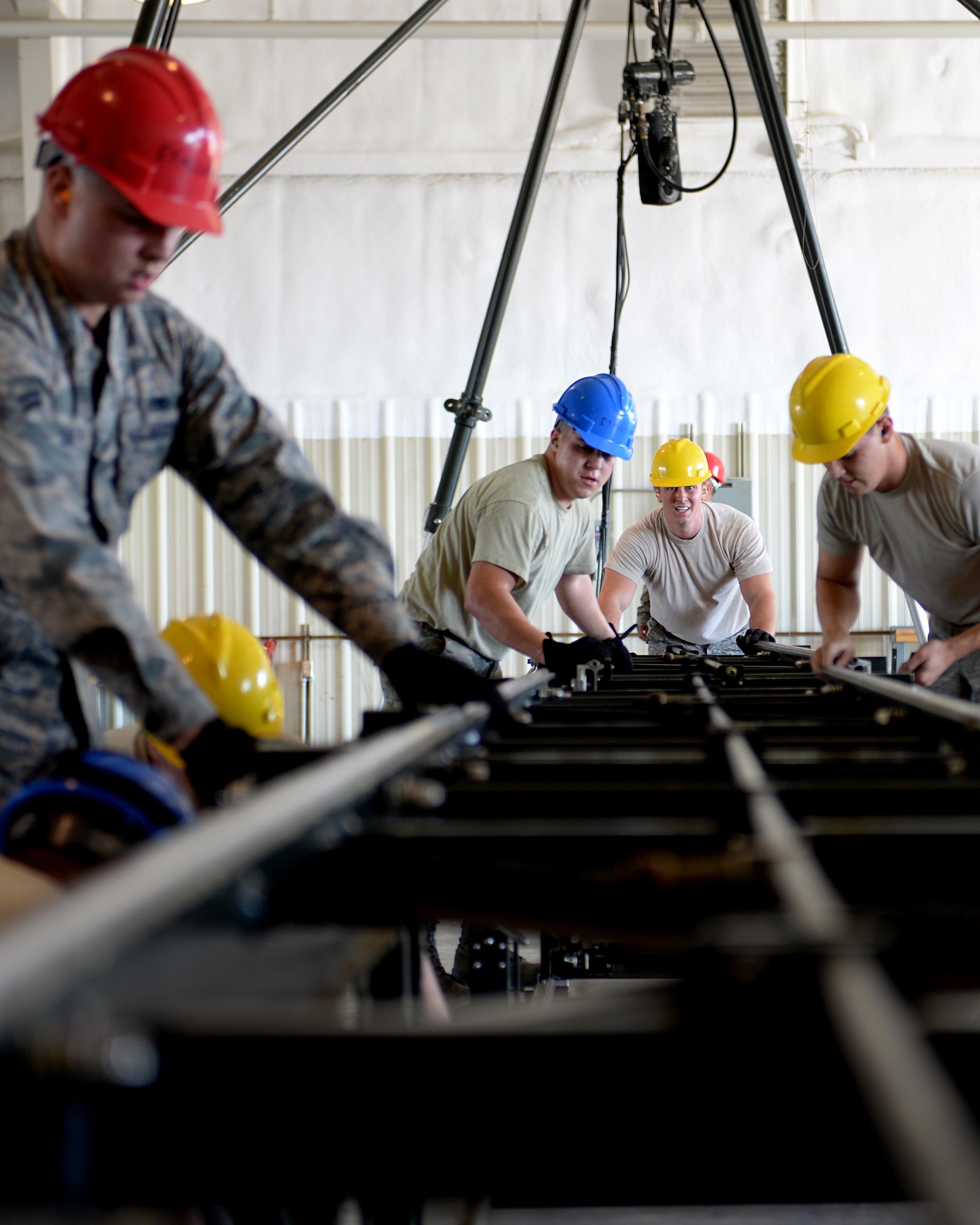 Airmen from the 28th Munitions Squadron assemble a munitions assembly conveyer during the Global Strike Challenge at Ellsworth Air Force Base, S.D., Sept. 26, 2014. Airmen participating in the event were carefully selected through their performances during weekly competitions over the last several months. (U.S. Air Force photo by Airman 1st Class Rebecca Imwalle/Released)