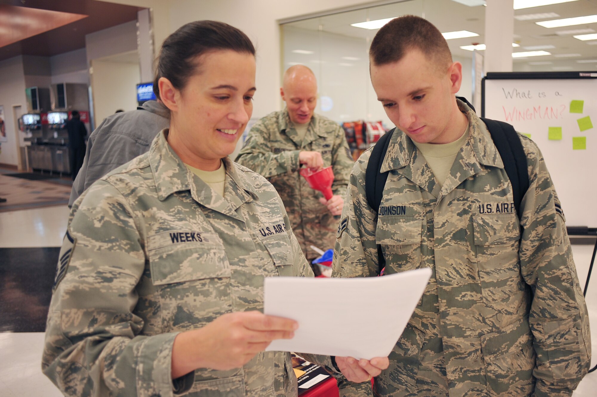 U.S. Air Force Master Sgt. Allison Weeks, 354th Medical Operations Squadron mental health flight chief, talks to Airman 1st Class James Johnson, 354th Maintenance Squadron Aerospace Ground Equipment technician, about the benefits of the Early Mental Health Help-Seeking Campaign at Eielson Air Force Base, Alaska, Sept. 23, 2014. The campaign is aimed to reduce the stigma of seeking mental health support and promote early help seeking. (U.S. Air Force photo by Staff Sgt. Jim Araos/Released)