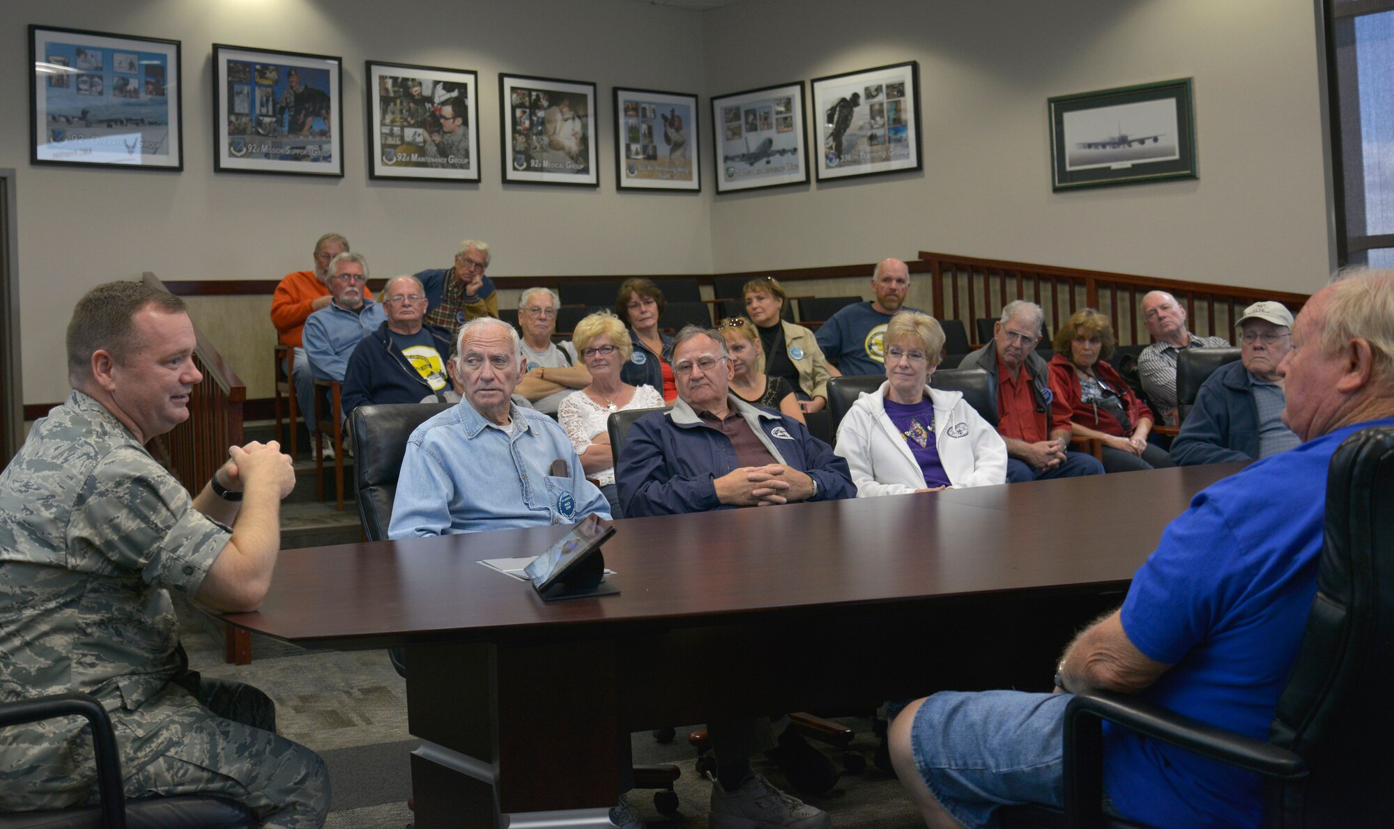 Col. Brian McDaniel, 92nd Air Refueling Wing commander, speaks with the Early Ford V-8 Club members during a base tour at Fairchild Air Force Base, Washington, Sept. 26, 2014. The tour consisted of 36 club members including several retired veterans from different branches of the military. (U.S. Air Force photo by Airman 1st Class Janelle Patiño/Released)