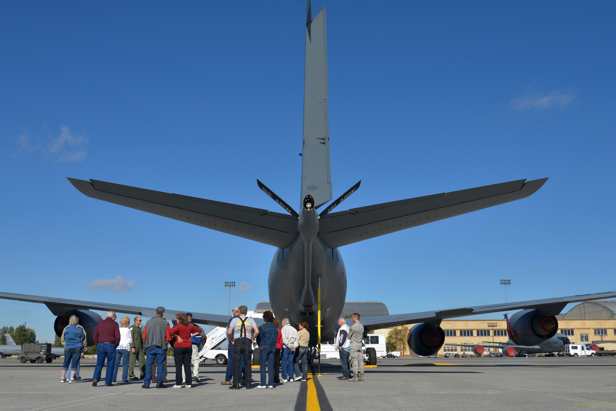 Members of the Early Ford V-8 Club walk around a KC-135 Stratotanker during a base tour at Fairchild Air Force Base, Washington, Sept. 26, 2014. The club members explored a static display of a KC-135 to better understand Fairchild's mission. (U.S. Air Force photo by Airman 1st Class Janelle Patiño/Released)