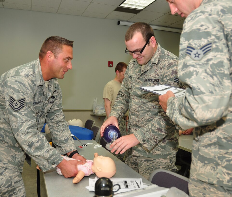 Tech. Sgt. Chad Bruntjens, 932nd Airlift Wing, talks to other Airmen about proper technique to use on smaller children during basic lifesaving skills classes held at the Illinois unit.  (U.S. Air Force photo/SSgt. Amber Hodges)