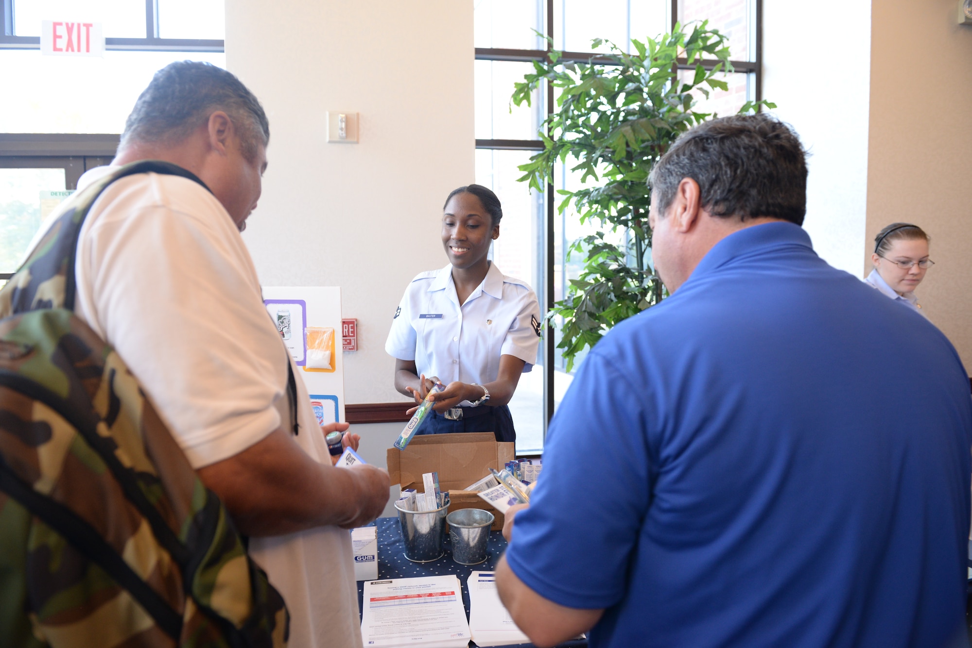 Airman 1st Class Adrian Baxter passes out oral care supplies at the Dental booth during the 29th annual Retiree Appreciation Day at Scott Air Force Base, Ill., Sept. 27, 2014. There were many informational booths representing various organizations around Scott, including the 375th Medical Group, Scott AFB Education Office, Airman and Family Readiness Center, TRICARE, and Red Cross. The day also included free breakfast, donated by the Commissary and hosted by the Club, as well as prize drawings for gift cards. (U.S. Air Force photo by Airman 1st Class Erica Crossen)