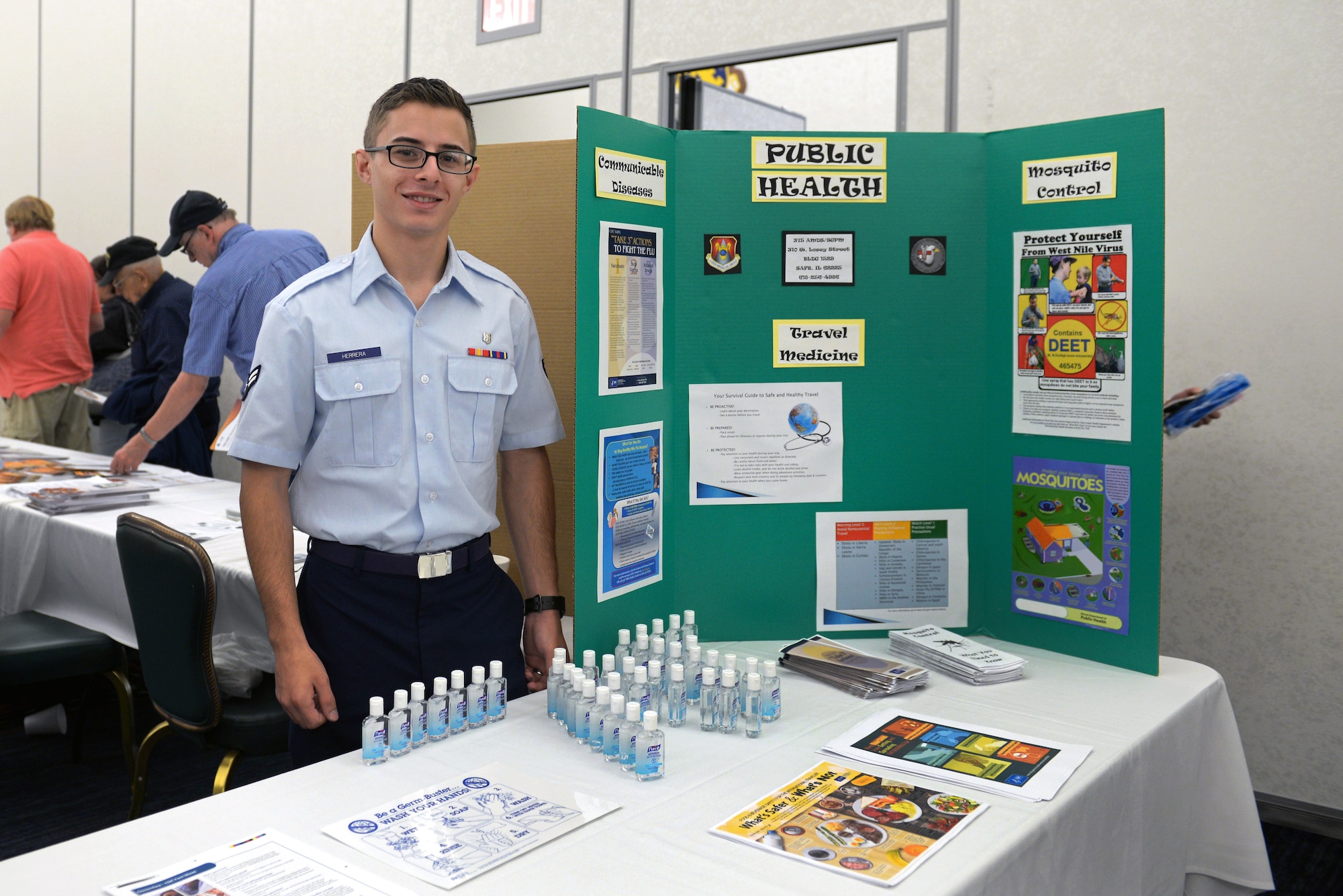 Airman 1st Class Brandon Herrera mans the Public Health booth at Retiree Appreciation Day at Scott Air Force Base, Ill., Sept. 27, 2014. Crowds of retirees and their families gathered for the 29th annual Retiree Appreciation Day. There were many informational booths from various organizations around Scott, including the 375th Medical Group, Scott AFB Education Office, Airman and Family Readiness Center, TRICARE, and Red Cross. The day also included free breakfast, donated by the Commissary and hosted by the Club, as well as prize drawings for gift cards. (U.S. Air Force photo by Airman 1st Class Erica Crossen)