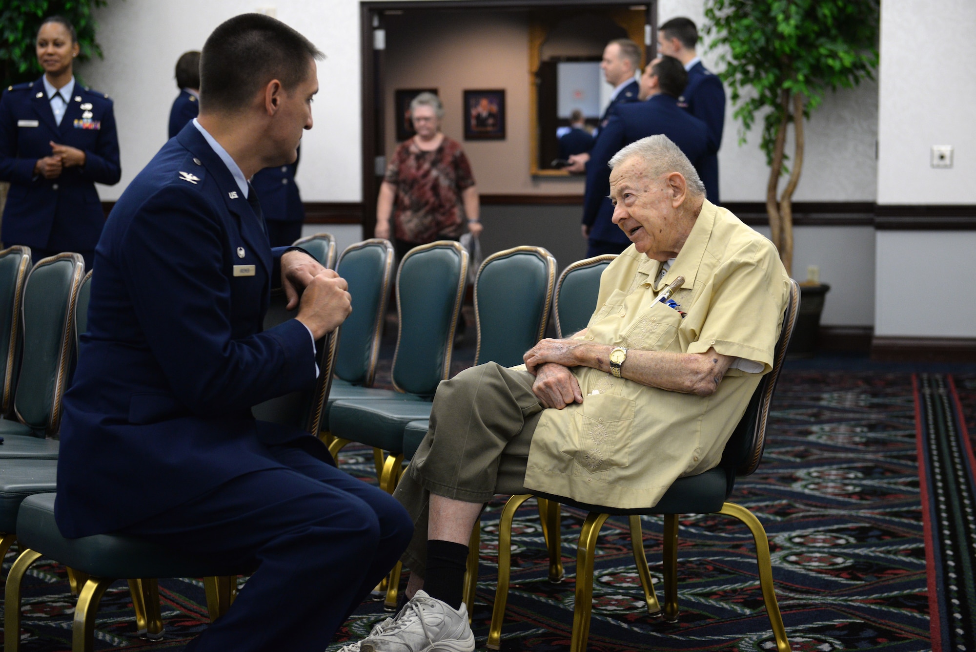 Col. Kyle Kremer, 375th Air Mobility Wing commander, listens to a retiree attendee at the annual Retiree Appreciation Day at Scott Air Force Base, Ill., Sept. 27, 2014. Team Scott took the opportunity to thank retirees for their service and honor them. There were many informational booths from various organizations around Scott, including the 375th Medical Group, Scott AFB Education Office, Airman and Family Readiness Center, TRICARE, and Red Cross. (U.S. Air Force photo by Airman 1st Class Erica Crossen)