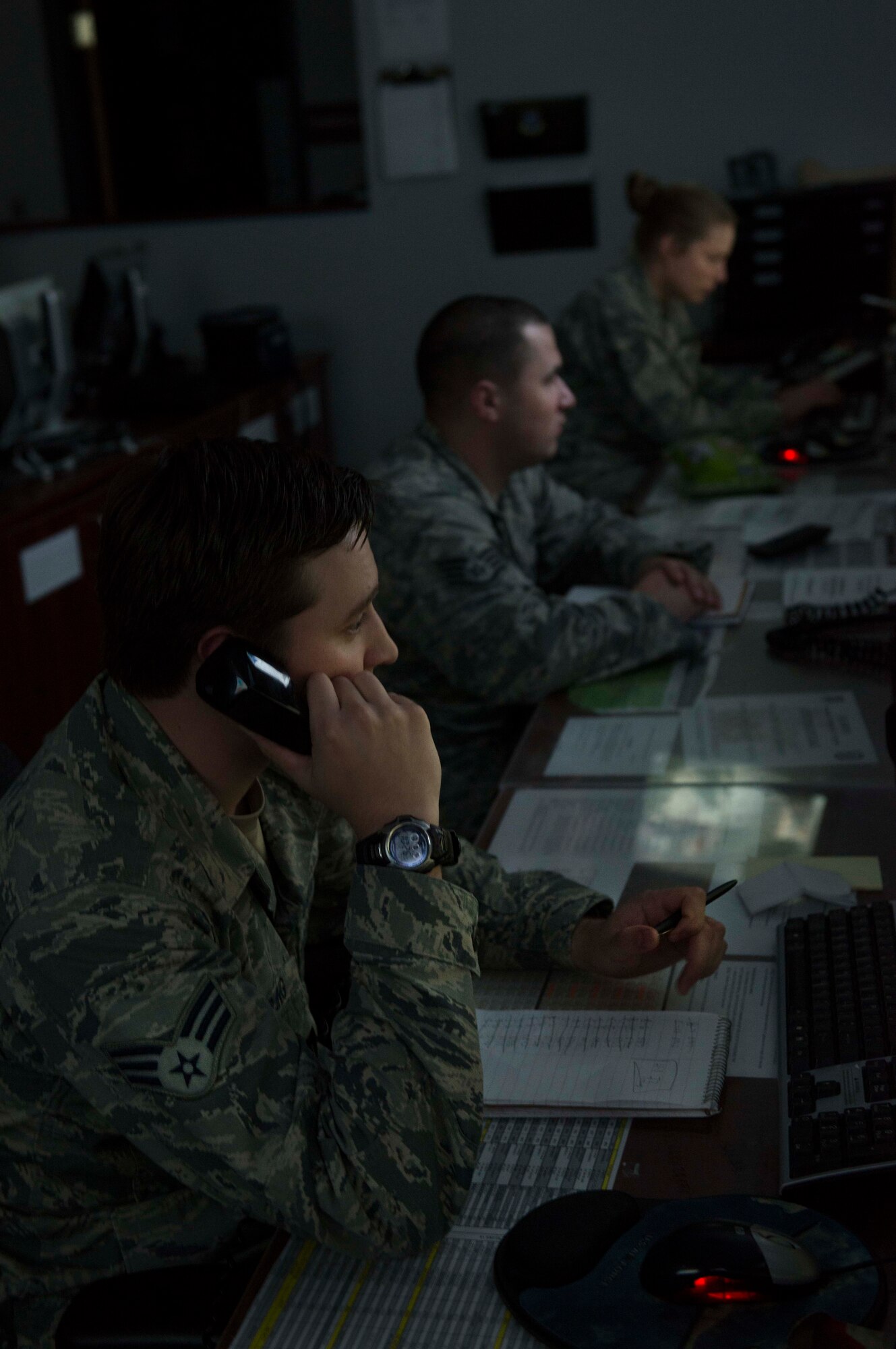 (From front to back) Senior Airman Shea Singerling, Staff Sgt. Tino Mong and Staff Sgt. Fawn Williams, 91st Security Support Squadron missile security controllers, monitor security in the missile field during their shift at the Wing Operations Center on Minot Air Force Base, Sept. 4, 2014. The WOC houses both security forces and maintenance Airmen, forming the foundation for missile wing operations. (U.S. Air Force photo/Airman 1st Class Lauren Pitts) 