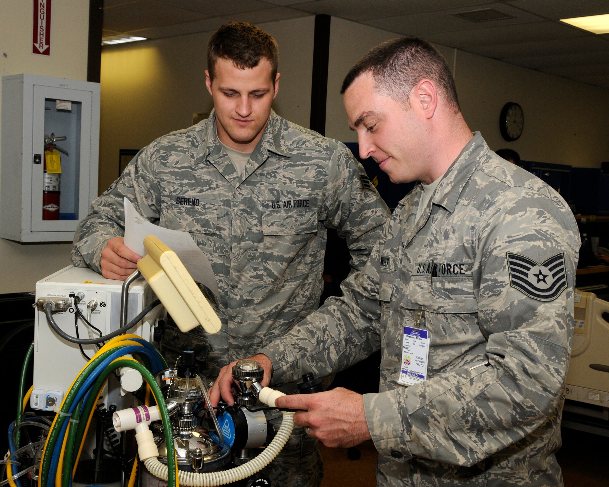 Senior Airman Timothy Sereno (left) and Tech. Sgt. Mark Dinnius, biomedical equipment technicians with the 182nd Medical Group,  inspect an anesthesia machine at Tripler Army Medical Center, Hawaii, September 10, 2014. They are from a group of 43 MDG members participating in overseas annual training September 6-20, 2014.  (U.S. Air National Guard photo by Tech. Sgt. Todd Pendleton) (Released)
