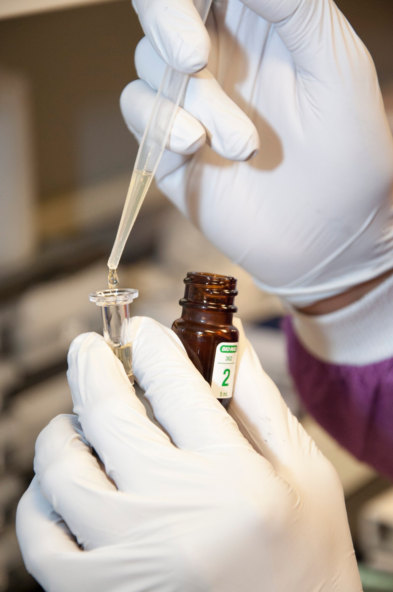A medical laboratory technician prepares a sample for a creatine kinase test Sept. 19, 2014, at the medical treatment facility on Dover Air Force Base, Del. The test is generally the first test a doctor will order to check for muscle trauma. (U.S. Air Force photo/Senior Airman Jared Duhon)