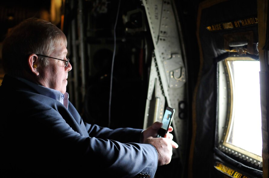 A civilian employer takes photos out the window of a C-130 Hercules during a familiarization flight at the Employer Support of the Guard and Reserve “Breakfast with the Boss” at the 182nd Airlift Wing in Peoria, Ill., Sept. 17, 2014. The attendees visited the base to see firsthand how their employees serve the Illinois’ reserve military and how employers play an important role in the defense of the nation. The Department of Defense established ESGR in 1972 to promote the relationship between service members and their civilian employers. (U.S. Air National Guard photo by Staff Sgt. Lealan Buehrer/Released)