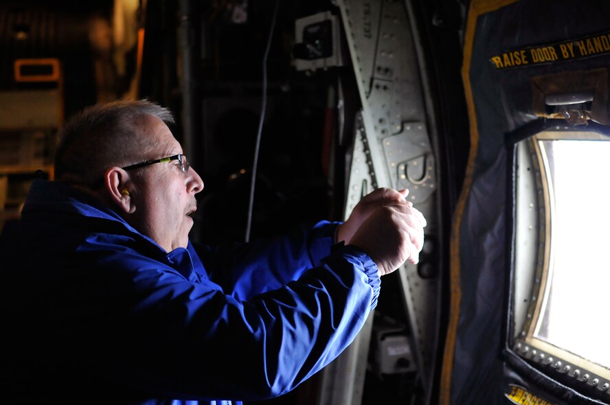 A civilian employer takes photos from a C-130 Hercules in flight during the Employer Support of the Guard and Reserve “Breakfast with the Boss” at the 182nd Airlift Wing in Peoria, Ill., Sept. 17, 2014. The attendees visited the base to see firsthand how their employees serve the Illinois’ reserve military and how employers play an important role in the defense of the nation. The Department of Defense established ESGR in 1972 to promote the relationship between service members and their civilian employers. (U.S. Air National Guard photo by Staff Sgt. Lealan Buehrer/Released)