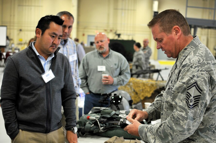 U.S. Air Force Master Sgt. Daniel P. Svymbersky, aircrew flight equipment superintendent of the 182nd Operations Support Squadron, shows a civilian employer a piece of aircrew equipment during the Employer Support of the Guard and Reserve “Breakfast with the Boss” at the 182nd Airlift Wing in Peoria, Ill., Sept. 17, 2014. The attendees visited the base to see firsthand how their employees serve the Illinois’ reserve military and how employers play an important role in the defense of the nation. The Department of Defense established ESGR in 1972 to promote the relationship between service members and their civilian employers. (U.S. Air National Guard photo by Staff Sgt. Lealan Buehrer/Released)
