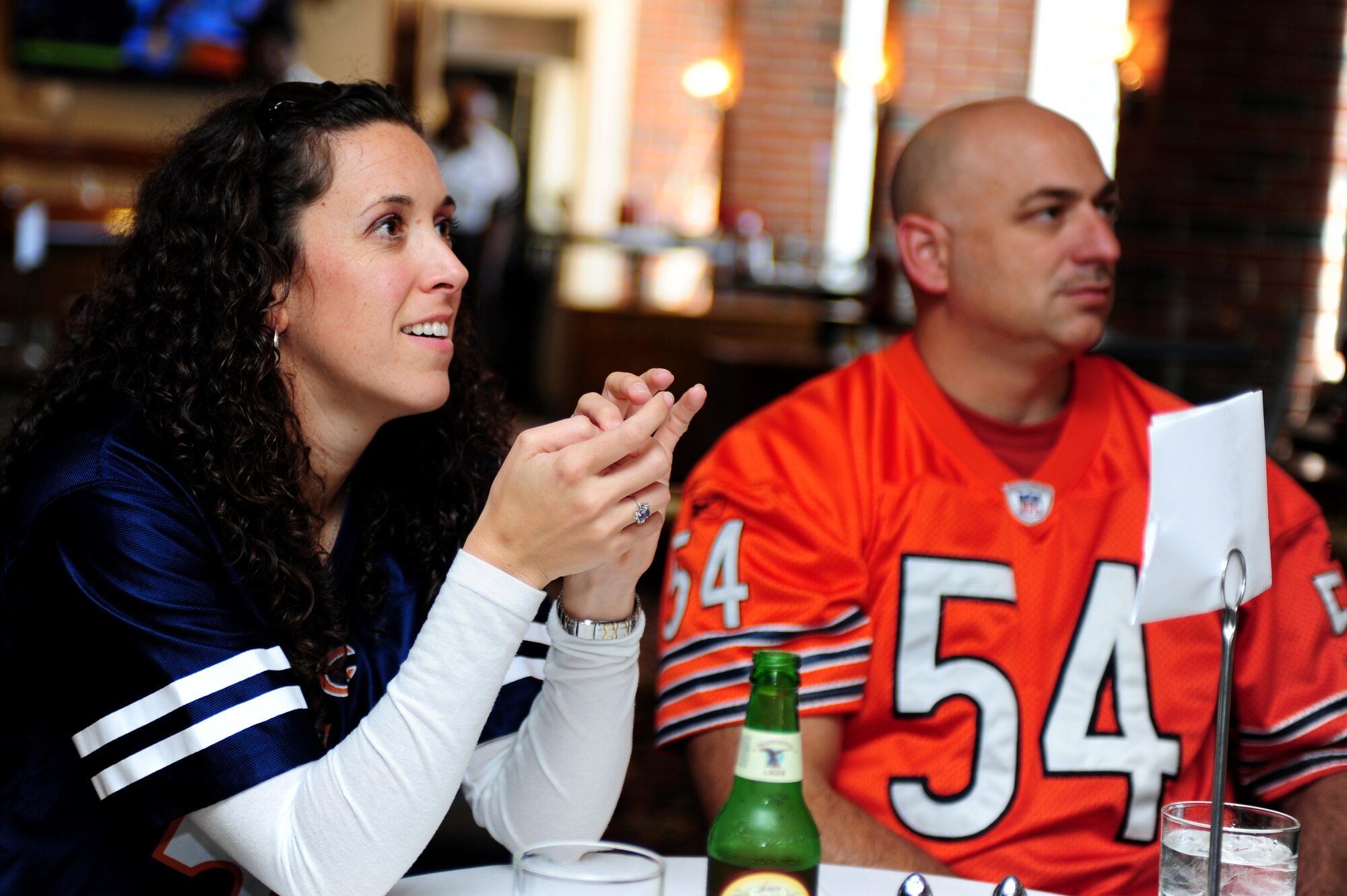 U.S. Air Force 2nd Lt. Jennifer Young, 633rd Force Support Squadron readiness and plans chief, and U.S. Army Sergeant 1st Class Brooks Young, 2nd Battalion, 183 Regimental Training Institute lead instructor, watch a football game at the Langley Club on Langley Air Force Base, Va., Sept. 29, 2014.  Attendees were given the option to view any game they want on one of the many televisions provided by the club. (U.S. Air Force photo by Airman 1st Class Areca T. Wilson/Released) 