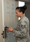 Staff Sgt. Britini Jennie, 436th Civil Engineer Squadron Airman dormitory leader, reprograms a dormitory resident’s lock Sept. 4, 2014, in building 414 on Dover Air Force Base, Del. The Airman dormitory leaders in coordination with Air Force Smart Ops for the 21st Century are attempting to create a fix to the increase in dorm lockouts. (U.S. Air Force photo/Airman 1st Class Zachary Cacicia) 