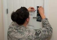 Staff Sgt. Britini Jennie, 436th Civil Engineer Squadron Airman dormitory leader, replaces the batteries in a dormitory resident’s lock Sept. 4, 2014, in building 414 on Dover Air Force Base, Del. There has been a 68 percent increase in the amount of dorm lockouts in 2014, compared to the previous year. (U.S. Air Force photo/Airman 1st Class Zachary Cacicia) 