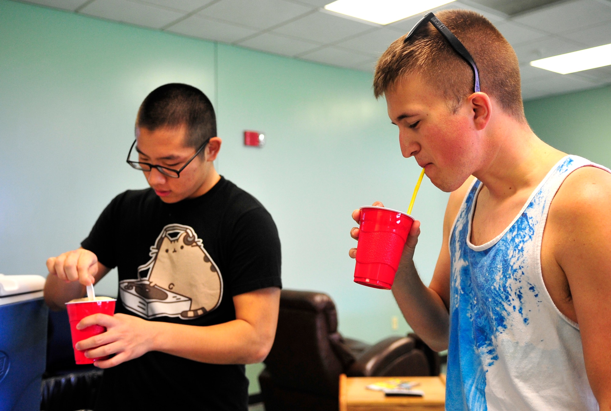 Airmen 1st Class David Moon (left) and Tryce Collins, 911th Air Refueling Squadron crew chiefs, enjoy root beer floats during a Dorm Dwellers Barbecue at Seymour Johnson Air Force Base, N.C., Sept. 27, 2014. Seymour Johnson is the first assignment for both Airmen, who said they appreciate events catered to dorm residents. (U.S. Air Force photo/Airman 1st Class Ashley J. Thum)