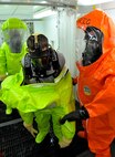 Illinois National Guardsmen practice decontamination during a weapon of mass destruction exercise at the 182nd Airlift Wing in Peoria, Ill., June 8, 2014. Soldiers and Airmen with the Illinois National Guard practiced entry, identification and decontamination training in conjunction with the Illinois Army National Guard’s 5th Civil Support Team. (U.S. Air National Guard photo by Staff Sgt. Lealan Buehrer/Released)