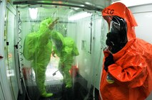 Illinois National Guardsmen practice decontamination during a weapon of mass destruction exercise at the 182nd Airlift Wing in Peoria, Ill., June 8, 2014. Soldiers and Airmen with the Illinois National Guard practiced entry, identification and decontamination training in conjunction with the Illinois Army National Guard’s 5th Civil Support Team. (U.S. Air National Guard photo by Staff Sgt. Lealan Buehrer/Released)