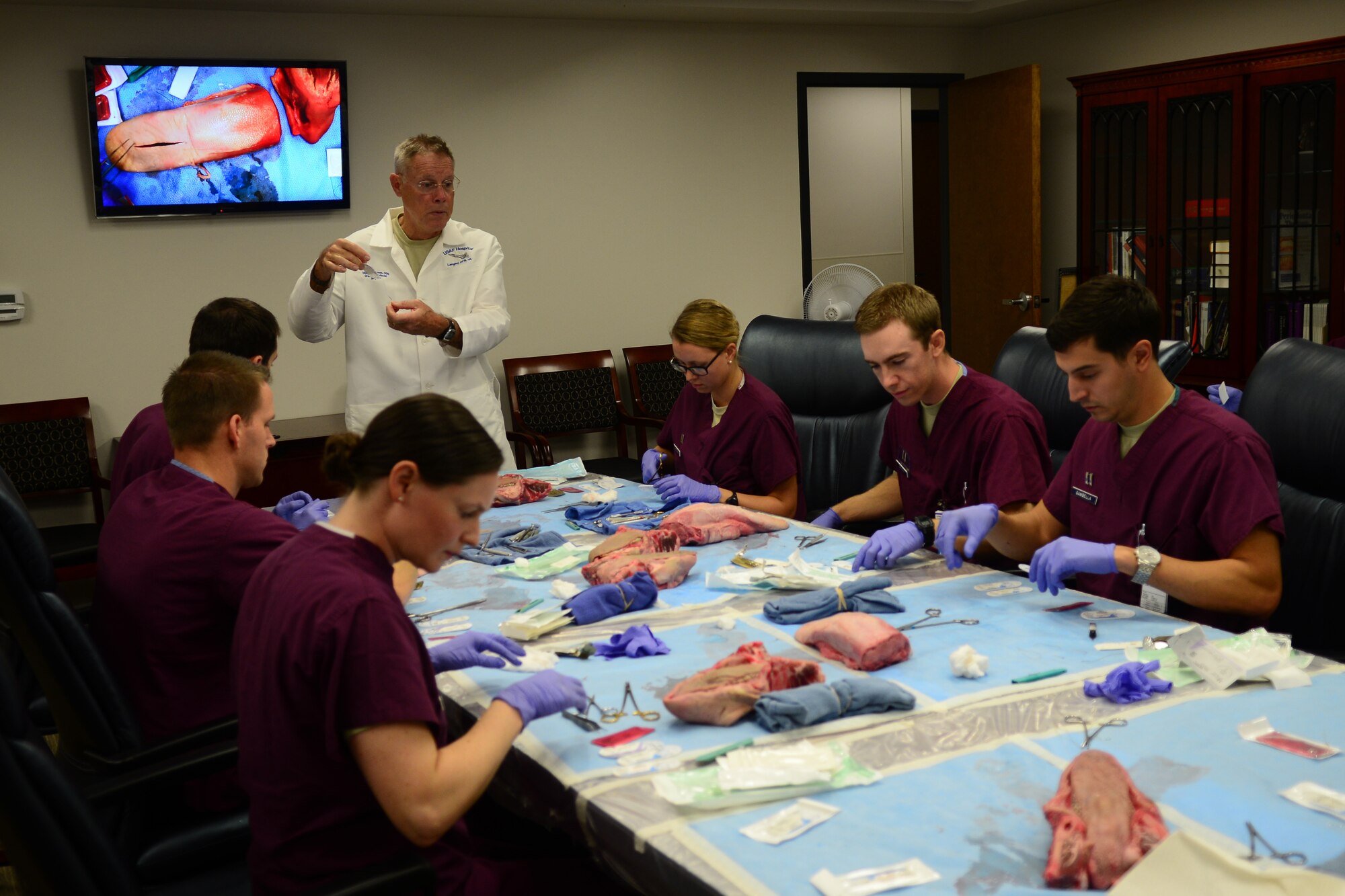U.S. Air Force Lt. Col. Marshall Humes, 633rd Dental Squadron maxillofacial surgery element chief, teaches 633rd DS dental residents suturing lessons in the USAF Hospital Langley dental clinic at Langley Air Force Base, Va., Sep. 25, 2014. The dental residents practiced Humes’ techniques on pig jaws and cow tongues for additional on-the-job training. Every year, there are six new dental residents operating in the course. (U.S. Air Force photo by Airman 1st Class Devin Scott Michaels)