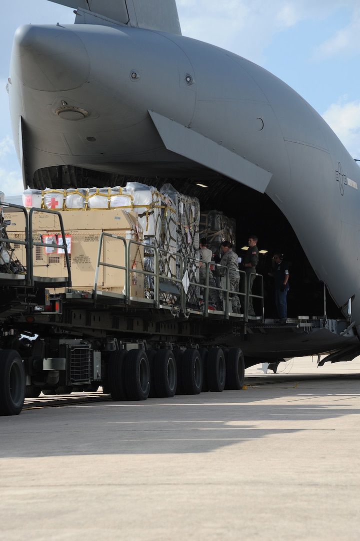 Airmen from the 502nd Logistics Readiness Squadron, Lackland JBSA, load medical supplies from the Air Force Medical Operations Agency onto a C-17 Globemaster III at Kelly Field Annex, Sept. 25, 2014. The C-17 was deployed from Altus AFB -- 97 Air Mobility Wing to support United States Africa Command and United Nations operations and efforts to fortify global health security infrastructure in the region and beyond. (U.S. Air Force photo by Senior Airman Krystal Jeffers)