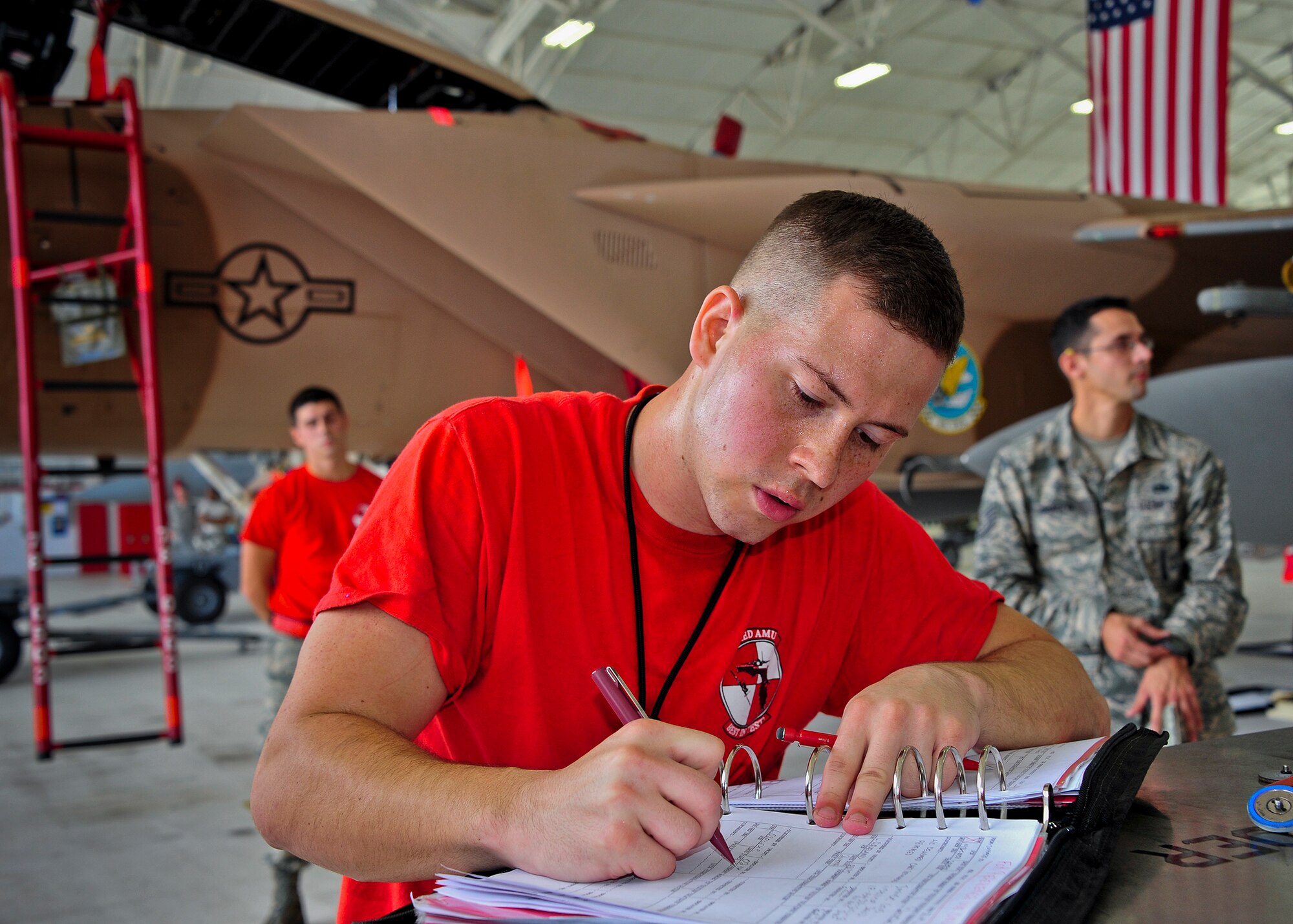 Senior Airman Lance O’Rourke of the 96th Aircraft Maintenance Squadron Red, reviews the aircraft forms after his team loaded AIM-120 missile onto an F-15 Eagle during the 96th Maintenance Group’s quarterly weapons load crew competition Sept. 26 at Eglin Air Force Base, Fla. Other members on O'Rourke's team were Staff Sgt Isaac Tolentino and Airman 1st Class Colin Reeder. (U.S. Air Force photo/Ilka Cole) 